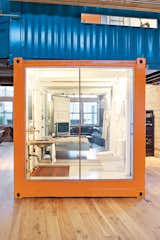 To say that Jeff Wardell and Claudia Sagan's apartment is truly unique would certainly be an understatement. Their 3,200-square-foot San Francisco abode, formerly a Chinese laundry and tooth-powder factory, holds onto its industrial roots with a tangerine-toned shipping container in the middle of the couple's living room. The container serves dual purposes as a guest bedroom, housing a Pat Carson–designed Murphy bed, and home office with the glass wall transforming from opaque to clear with a flick of a switch.