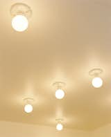 In the kitchen, compact fluorescent lightbulbs affixed to the ceiling are a simple solution.