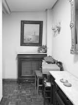 Estudio Untercio coated the custom MDF cupboards in the hallway with a coat of white lacquer paint, giving the space a brightness that was missing in the pre-renovated hallway.  Photo 6 of 10 in A Childhood Home in Madrid Grows Up