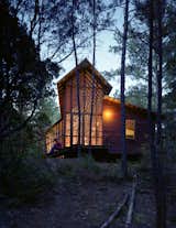 “I wanted more of a skeletal look for this house, and less of a chunky, log-cabin look,” says architect Harry Panton of his Texas bunkhouse. He added stark steel bracing across the entire length of the porch’s roof structure and thinks of the getaway as "a bridge into the woods."  Photo 6 of 10 in Modern Gables by Kelsey Keith