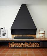 This black, monolithic fireplace anchors the living room. Via desire to inspire. (Pin)  Photo 2 of 6 in Pinboard of the Day: Fireplaces by Eujin Rhee
