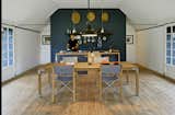 The Simple Life-Two Copenhagen designers handcrafted a trio of rural barns into a summerhouse the melds past and present seamlessly. In the kitchen area and throughout the home, Mads Odgård, shown here, and Mette Lyng Hansen mixed Odgård’s pieces, such as the Odgård kettle for Raadvad and custom table, with Ikea basics and the Workshop pendant lamp by Louis Poulsen. Photo by: Åke E:son Lindman