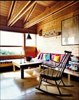 Norwegian Wood-Jürgen Kiehl upgraded his 1970s Norwegian vacation home from the original structure he built as a young architect. Here, built-in benches function both as seating and as spare beds in the living room. His wife, Kari Holm, says the striped, hand-woven fabric she found in Greece is indestructible, and the cork flooring throughout the house has gone 40 years without needing replacing. Photo by: Pia Ulin