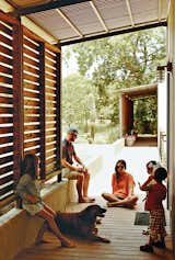 Red-cedar screens shade the modules’ western walls, and part of the walkway that connects them, from the Texas sun.  Photo 9 of 11 in Modular Compound is the Ultimate Retreat for Three Generations