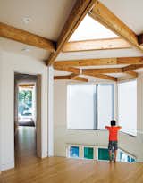 The couple’s son, Rio, pauses on the mezzanine, which leads to the bedrooms.