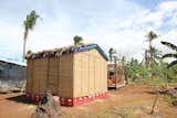 Soda crates serve as a foundation and prevent the structure from taking on water, as does the heavy-duty plastic beneath the thatch on the roof.  Search “lost and foundation” from Shigeru Ban Designs Temporary, Easy-to-Build Shelters for Disaster-Prone Areas