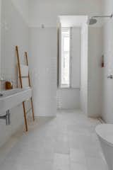 White tiles — hydraulic ones on the floor and “biselado” (meaning “beveled”) ones on the walls — make for a tranquil bathroom.