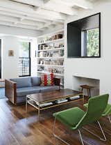 A vintage sofa purchased from Open Air Modern mixes with Low Pad chairs, by Jasper Morrison for Vitra, in the living room, which features a window inspired by Marcel Breuer’s Whitney Museum of American Art.