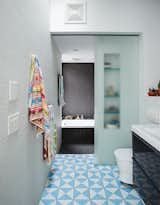 The second-floor bathroom includes a washroom that can be closed off from the bathing area with a sliding glass door. Bauer and Magid can supervise the kids’ baths or use it as a steam room.