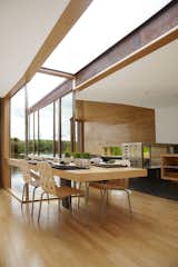 Architect Jim Garrison takes on this lakeside retreat in Albion, Michigan. The table in the common area, which continues the FSC-certified maple used throughout the interior, is mostly used for dining and serves as the hub of the house.