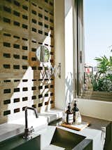 Perforated concrete blocks in the guest bathroom provide ventilation and discreet views of the patio.