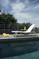 The Alizé Sunlounger from Fermob is an outdoor essential that has been met with a technical fabric for durability and comfort. The tear-proof fabric is soft and responsive to the touch, so a cushion or towel does not need to be used with the chaise. The frame of the chaise lounge features artful curves, giving the Alizé a silhouette that sets it apart from traditional loungers. Crafted in an elegant white, the Alizé is undeniably sophisticated.