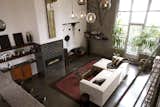 Large windows pull natural light into the space. The fireplace is covered with black tile from Heath.  Photo 2 of 6 in San Francisco Loft in a Former Movie Palace by Allie Weiss