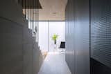 Hallway and Medium Hardwood Floor Though the minimal layout maxmizies open space, moments of contrast, such as the wood grain against the perforated metal divider, animate the interior.  Photo 5 of 10 in Super Minimal Steel and Concrete Villa with an Unusual Facade