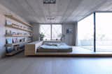 Bedroom, Bed, Shelves, Recessed Lighting, and Light Hardwood Floor The simple yet spacious master bedroom opens up to a private terrace.  Search “meet-the-architects-la” from Super Minimal Steel and Concrete Villa with an Unusual Facade