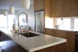 The countertop is Living Stone, and all appliances are Jenn-Air.  Photo 1 of 1 in Kitchen by Designer from Room We Love: Sunny Modern Kitchen in Kansas