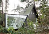 Logical Extension-A tiny home in the Belgian forest gained some serious square footage with dmvA Architecten's glass walled addition that visually connects the residents with their surroundings. Photo by: Frederik Vercruysse  Photo 7 of 13 in TP4 by TomTom from April 'Outdoor' Issue Preview