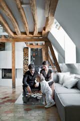 Herrman, his wife, Cécile, and their young daughter, Rose, play on the Pont table by Ligne Roset. The Carmo sofa is by Anders Nørgaard for BoConcept.