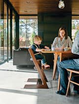 Amy and Jeremy Clark join their son, Edison, in the dining room; the Thatcher chairs by Newport Furniture and a dining table by Caperton of West Virginia are both from Room & Board. Edison’s high chair is the Tripp Trapp model by Stokke.
