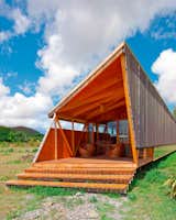 These temporary residences are prefabricated on the mainland before reaching their destination to ensure minimal impact on the environment. Lifted on pillars to further diminish interference with the natural terrain, each hut houses six people.  Easter Island, Chile. By AATA Arquitectos from the book Rock the Shack, Copyright Gestalten 2013.  Photo 9 of 13 in Rock the Shack: Cabin Love by Sara Carpenter