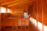 The geometric framing lining the interiors echoes the facade's asymmetrical shape. Easter Island, Chile. By AATA Arquitectos from the book Rock the Shack, Copyright Gestalten 2013.  Search “tropicalia-cocoon.html” from Rock the Shack: Cabin Love