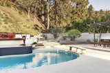 Mass Studio completed the renovation of a 1960s house in Brentwood, California, that came complete with a classic midcentury kidney pool. During the renovation, the patio and area around the pool was refreshed with a lounge area, fire pit, and plants.