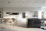Built-in kitchen cabinets and a monolithic island help keep the space uncluttered. The wall ovens are from Gaggenau.