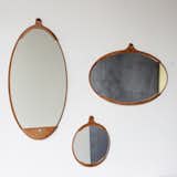 The Fairmont Wall Mirrors represent the perfect blend of rusticity and elegance. Each mirror in the series—round, long oval, and wide oval—features a hand-stitched leather frame that is fixed with brass rivets. The leather frame functions like a pocket for the mirror glass, and the natural material will darken over time, giving each mirror a distinct patina.