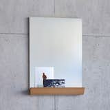 Designed by Andrea Stemmer for SCP, the Jules Mirror is an unframed, rectangular portrait mirror that works well in an entryway or above a bureau or vanity. The mirror features a solid oak storage shelf at its base, which can be used to hold knickknacks, makeup, keys, or favorite photographs and postcards. The shelf is made from a single piece of wood and is shaped like a half pipe, which counters the rigid straight lines of the mirror with a warm curvature. The result is a simple and sophisticated mirror that provides practical storage that does not overcomplicate the design.  Photo 4 of 8 in Modern Mirrors to Redefine Your Interiors by Marianne Colahan