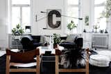A light filled living room with white walls is contrasted by dark furniture and beautiful accents.