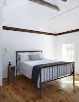 All of the home's wide-plank floors were reclaimed from the original farmhouse during the demolition process.  Photo 10 of 14 in Bedrooms by Shahdia Jamaldeen from A Mind-Bending Renovation Brings a Bold, Modern Addition to an Old Farmhouse