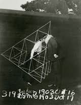 Alexander Graham Bell gives his wife, Mabel, a smooch in a tetrahedral kite, October 1903. Photo courtesy Library of Congress.