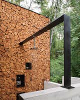 An outdoor shower is flanked by a highly functional (and attractive) wall designed for firewood storage. Via Stone Creek Camp. (Pin)  Photo 6 of 8 in Outdoor Showers We Love by Aileen Kwun from Pinterest Board of the Day: Landscape Architecture and Outdoors