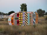 A neon textile-covered trailer sits in Marfa, Texas' El Cosmico. Via simply photo.