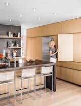Kitchen cabinets in Japanese elm are topped with Calacatta marble and wraparound concrete for the island.