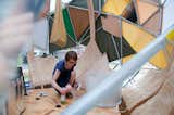 A volunteer prepping the interior of one of the geodesic-inspired Flock Houses.
