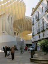 Metropol ParasolRounding a corner into Seville's Plaza de la Encarnación, architect J. Mayer H.'s massive waffle-like structure emerges out of the medieval streets, casting checkered shadows on the centuries-old buildings.  Photo 1 of 3 in Cathedral Without Walls