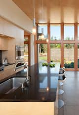 A view of the kitchen looking towards the front of the house.  Photo 7 of 11 in Modern in the Country