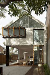 The rear of the Chistopher Polly-designed Elliott Ripper house shows the most impactful design moves—windows that allow light and air to enter the house. Breezway Altair louvers, Viridian Comfort Plus low-e glass, and Western Red Cedar–framed sliding glass doors on the ground floor and pivot stay windows on the second story allow residents to control how open or closed the house is. Photo by: Brett Boardman  Photo 4 of 8 in Impressive Australian Renovations by Andrea Smith from Space Race