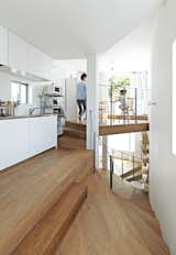How is a 921-square-foot, 44-level house possible? Witness Tokyo architect Akihisa Hirata’s mind-bending, shape-shifting solution to small-space living. At the top of the house, the twisting staircase sequence culminates in a compact galley kitchen, followed by an elevated dining area. Per the clients’ request, this last room abuts a south-facing terrace, overlooking a leafy shrine precinct. Expansive views from all sides of the house help it feel bigger.

Photo by: Koichi Torimura