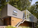 To clad the garage, Rappe opted for thermally treated poplar by Cambia. While it has a similar look to ipe, the wood is more durable, needs little maintenance, and is more affordable. The warm tone contrasts the aluminum siding Rappe used on the upper portion. "The home has a slim profile," he says. "We wanted to change the material on the garage level to give the impression that it's long and low."