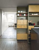 A sliding storage wall can be tucked aside to allow a seamless connection to the living and dining area.