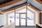 Windows, Picture Window Type, and Wood Girodo says the “high insulation performance of the shell” allows the building to function in a setting that experiences significant temperature fluctuations and extreme cold. Occupants of the front room, which functions as a reception area, can take in the views from its full-height windows in complete comfort.  Photos from This Prefab Ski School in the Alps Took 10 Days to Assemble