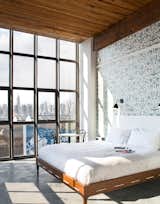 A bedroom with a view of Manhattan in the Wythe Hotel.