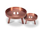 The Lift is both a functional serving piece and an attractive decorative accent. Handcrafted in brushed brass and finished in brushed copper, the Lift includes a circular tray and three balanced supporting legs. The middle of the tray features a simple open circle, adding a sense of cohesion to the piece. The Lift was designed by Felicia Ferrone and is available in two sizes.