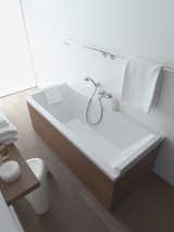 The updated acrylic bathtub features a neck rest for extended soaking and added comfort.