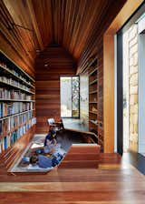 Office, Library Room Type, Medium Hardwood Floor, and Bookcase The library is lined in reclaimed spotted gum that Maynard says “brings with it wisdom from its previous life.” A stained glass window by Leigh Schellekens makes the contemplative room feel like a domestic chapel.  Photo 2 of 10 in 10 Creative Uses of Reclaimed Wood from This Transformed Melbourne House Resembles a Quirky Village