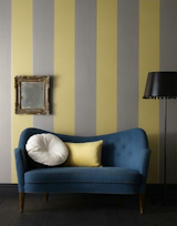 Imperial Wallpaper 

From designer staple Graham & Brown, the muted gray and mustard stripes pair nicely with the warm tones in mid-century furniture, $75 per roll.