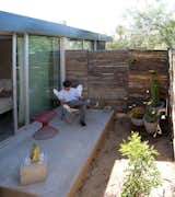 Sheltered from the harsh Arizona sun, a north patio serves several important functions. It extends the apartment’s footprint, encourages airflow, and provides a private corner for residents to relax away from the city buzz. “Physical connection to the outdoors is paramount in a small space. It’s physically and mentally healthier,” Hall says.  Photo 6 of 15 in backyard by Zech from Micro Dwellings in Phoenix Get Creative With Under 500 Square Feet