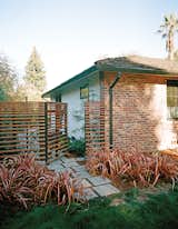For a project in Menlo Park, California, landscape architect Brennan Cox flanked pavers with drought-resistant Phormium ‘Rainbow Warrior.'  Photo 6 of 6 in Water-Saving Modern Gardens with Native Plants by Erika Heet from How to Make Your Garden Water-Free